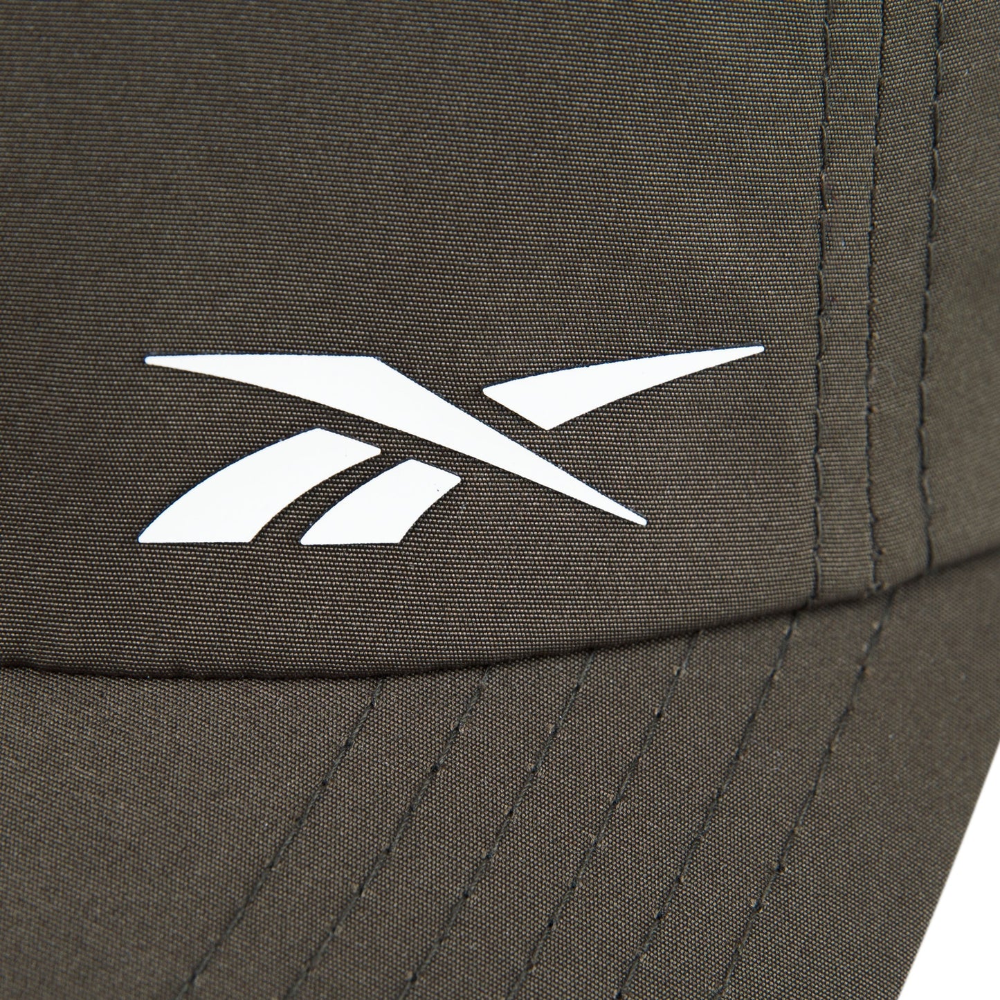 Close-up of the Reebok Flow Cap in brown, crafted from recycled polyester with a white Reebok logo, visible stitching, and a moisture-wicking sweatband for comfort.