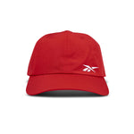 The Reebok Flow Cap is a red baseball cap with a curved brim and a white Reebok logo on the front left panel, shown against a plain white background.