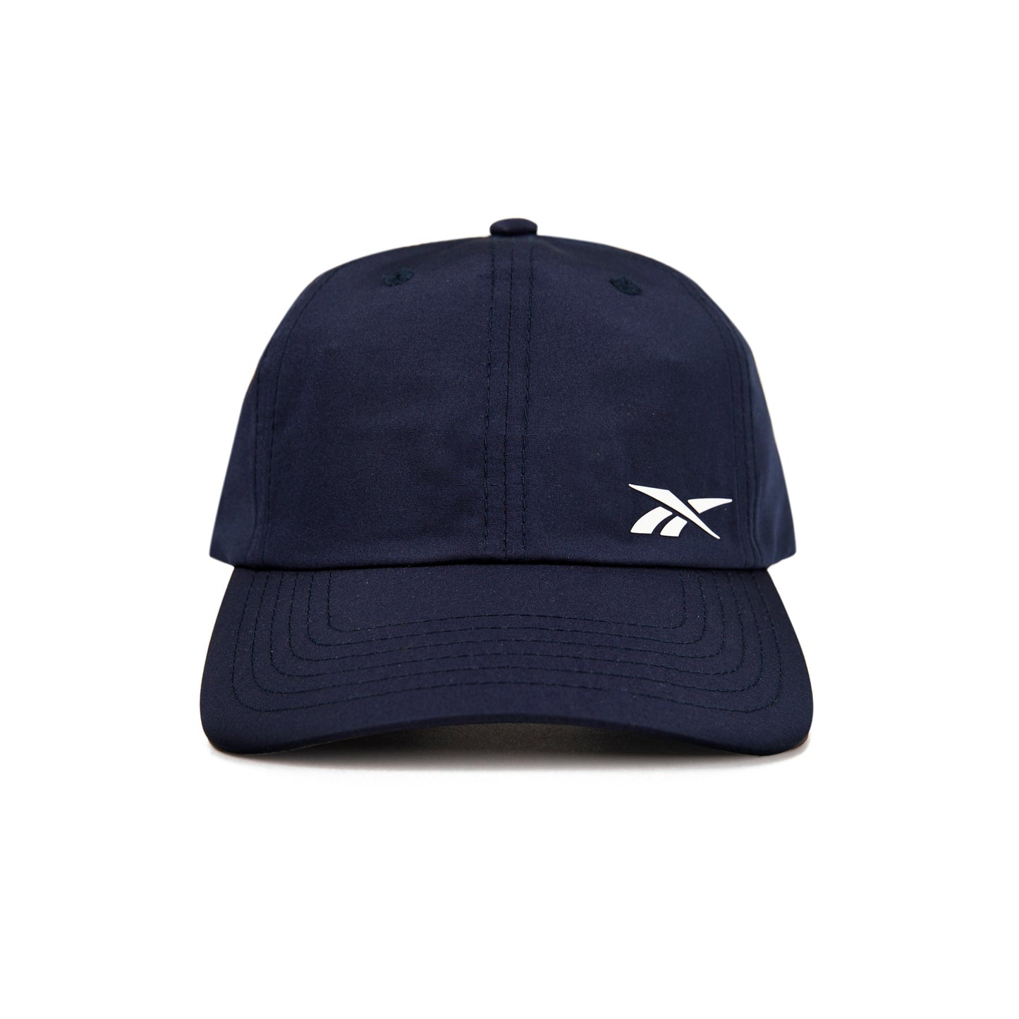 A front view of the Reebok Flow Cap in navy blue, featuring a small white Reebok logo on the left crown and a moisture-wicking sweatband for comfort.
