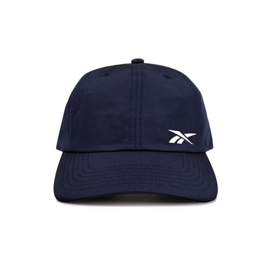 A front view of the Reebok Flow Cap in navy blue, featuring a small white Reebok logo on the left crown and a moisture-wicking sweatband for comfort.