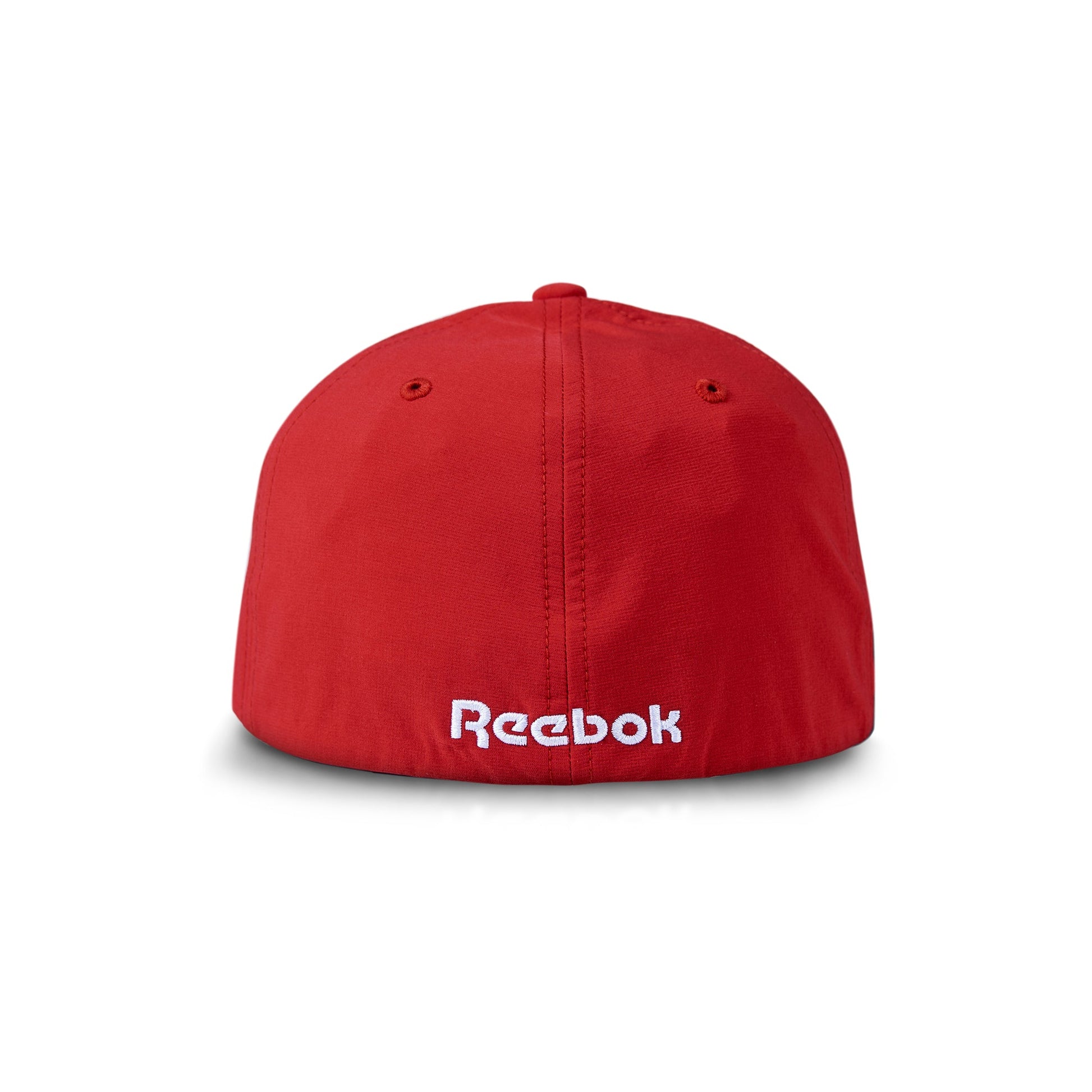The Reebok Range Cap is a red golf hat with "Reebok" embroidered in white on the back. It features visible stitching, moisture-wicking fabric, sun protection, and two top ventilation holes.