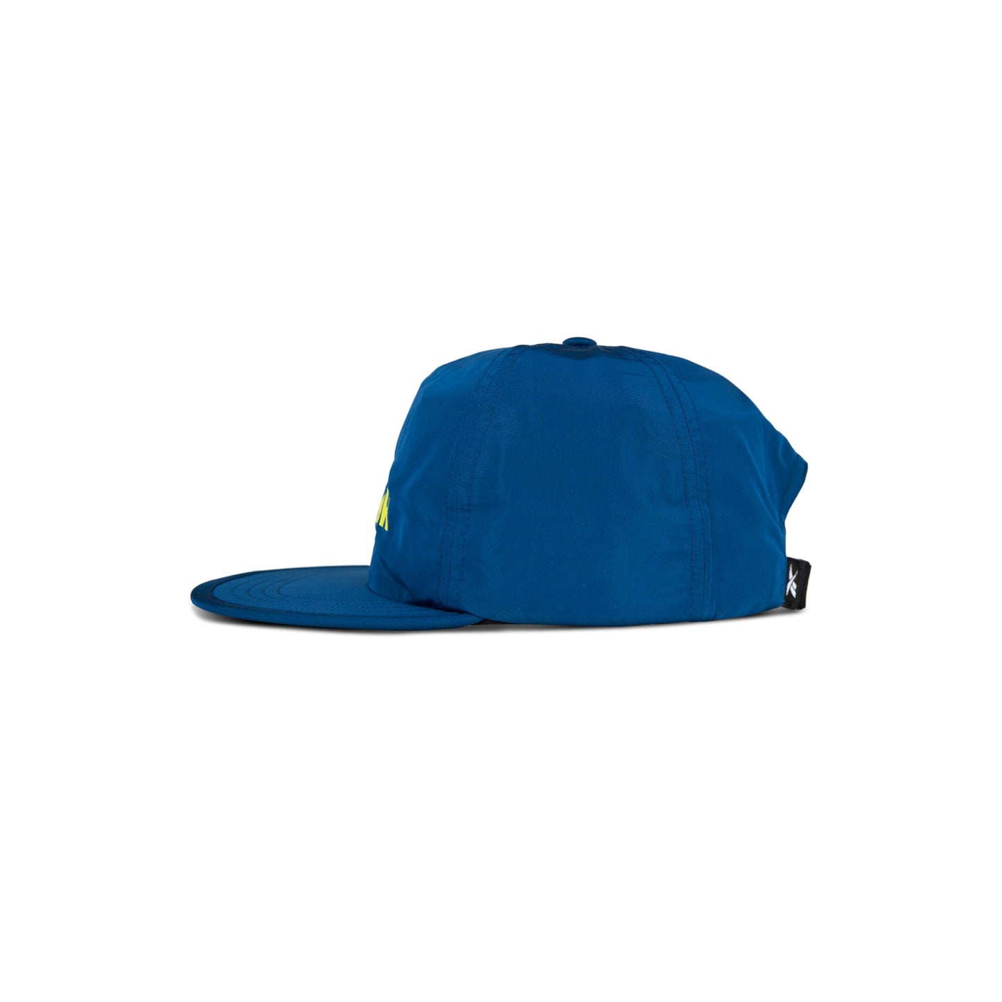 The Reebok Flat Brim Running Cap in blue is shown side-on against a white background. This lightweight running hat features moisture-wicking fabric and a small black tag at the back.