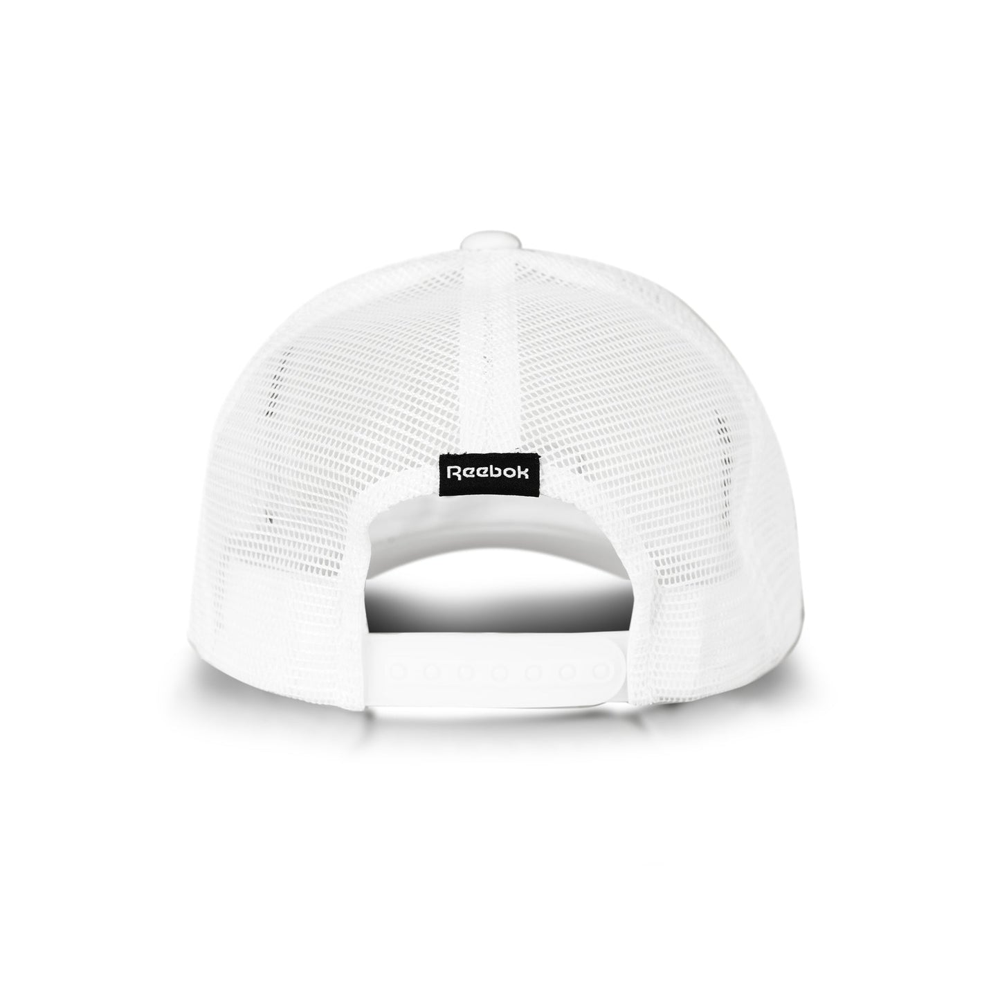 A white Reebok Deluxe Aero Cap trucker hat seen from the back, with breathable mesh, an adjustable snap closure, and a small black Reebok logo tag above the opening.