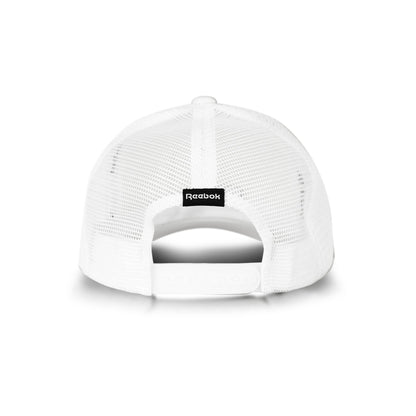A white Reebok Deluxe Aero Cap trucker hat seen from the back, with breathable mesh, an adjustable snap closure, and a small black Reebok logo tag above the opening.