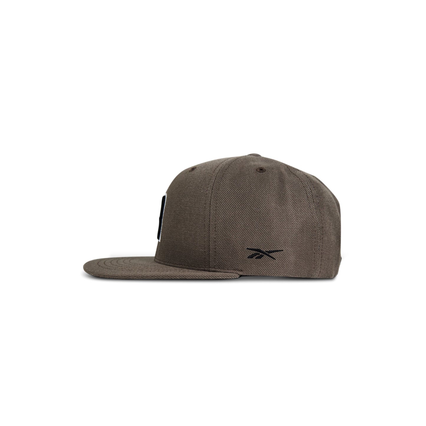 A side view of the Reebok Identity Drop R Cap in brown, showcasing a flat brim, structured crown, small black side Reebok logo, and a classic snapback closure for adjustable fit.