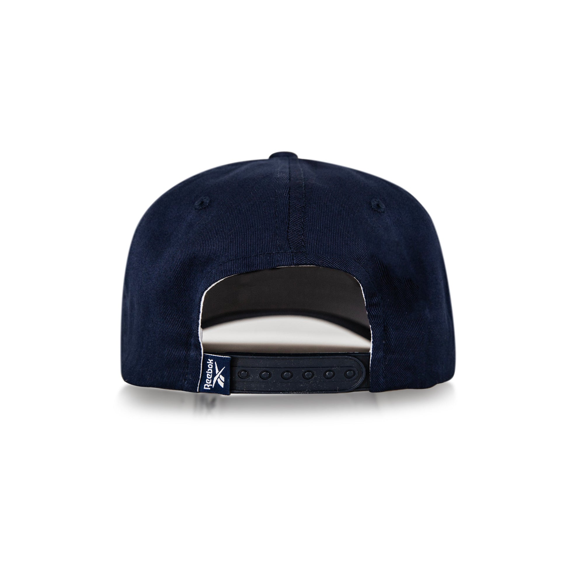 The Reebok Classic 5 Cap in navy blue is shown from the back on a white background, featuring an adjustable snapback, a small logo tag on the left side, and moisture-wicking fabric.