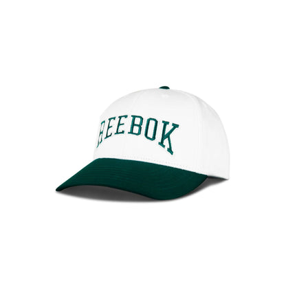 The Reebok Gameday Cap features a white crown, dark green brim, and "REEBOK" embroidered in green on the front. Displayed against a plain white background.