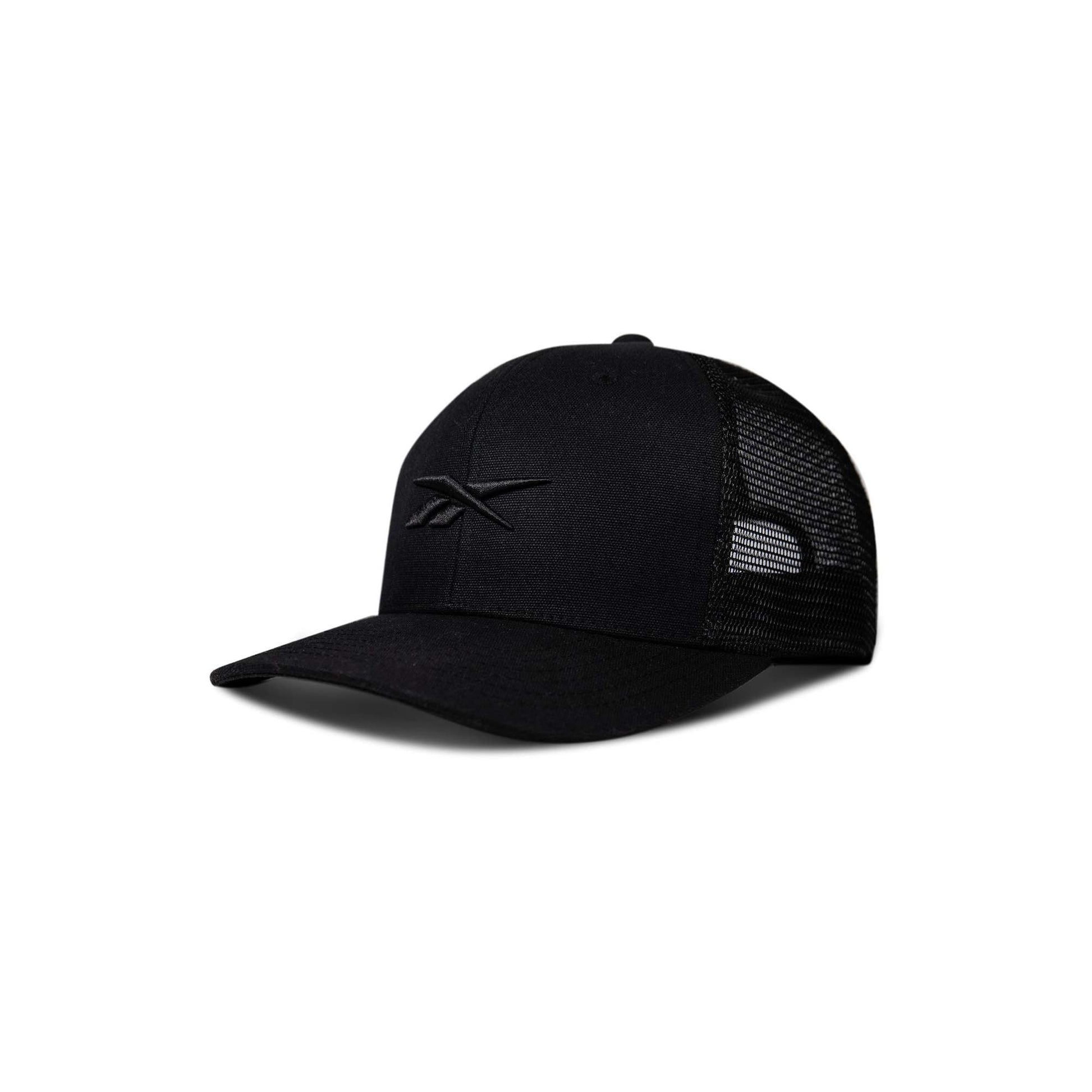 The Reebok Embroidered Vector Trucker Cap is black with a curved brim, mesh back panels, and a minimalist embroidered logo. Shown angled left on a plain white background.