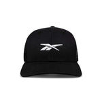 The Reebok Embroidered Vector Trucker Cap is shown from the front against a white background, featuring a black design with a white embroidered Reebok logo on the front.