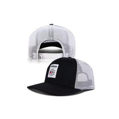 Front and back views of the Reebok Woven Patch Vector Trucker Cap: a black and white mesh hat with a curved brim, woven patch logo, and adjustable snapback closure.