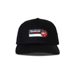 Front view of the Reebok Basketball Trucker Cap featuring a mesh back, snapback closure, and a front rectangular patch with the Reebok logo, "BASKETBALL," and a red basketball illustration.