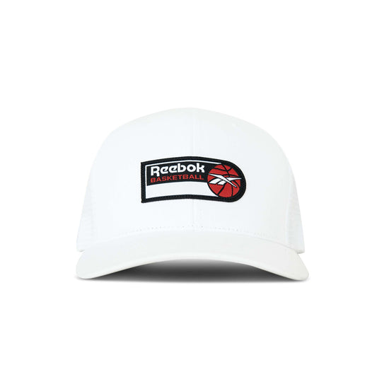 The Reebok Basketball Trucker Cap is a white snapback hat with a curved brim, featuring a logo patch and red basketball graphic on the front, perfect for adding sporty style to any look.