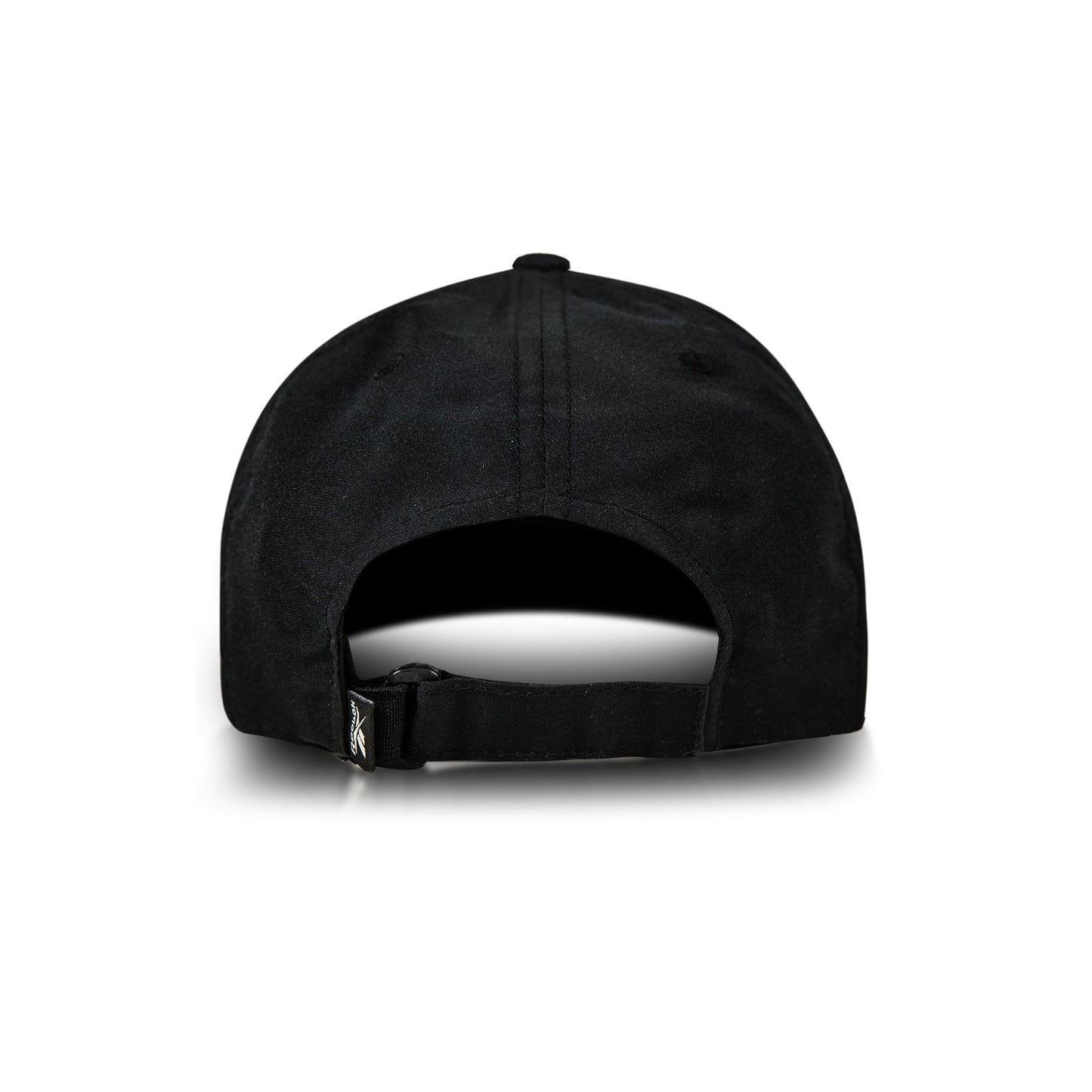 A black Reebok Flow Piped Cap is shown from the back with an adjustable strap and small left-side tag. Made from recycled polyester, it has a moisture-wicking sweatband and appears against a white background.