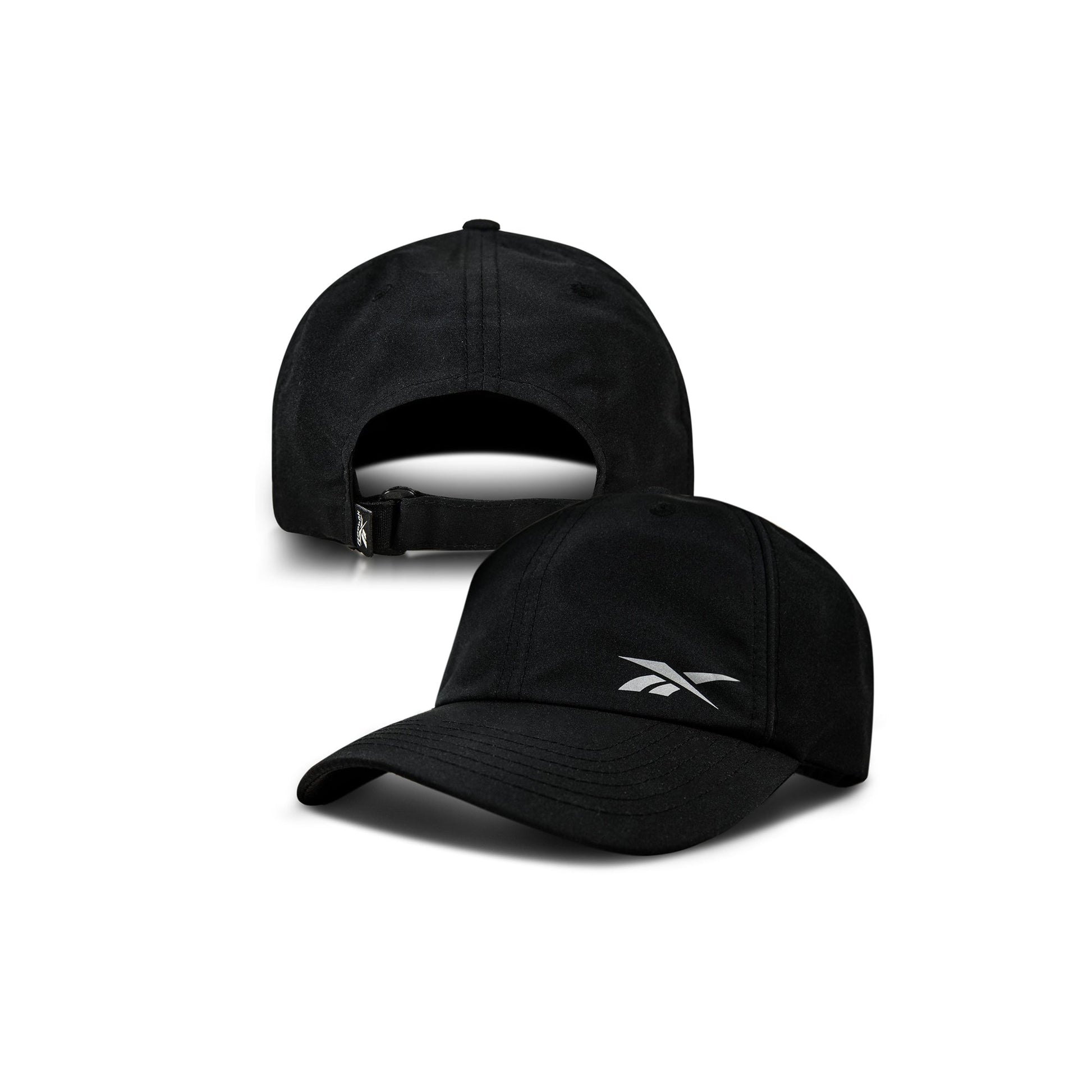 Two black Reebok Flow Piped Caps are displayed from different angles: one shows the front with a white Reebok logo, while the other shows the back with an adjustable strap and buckle. Includes a moisture-wicking sweatband for comfort.