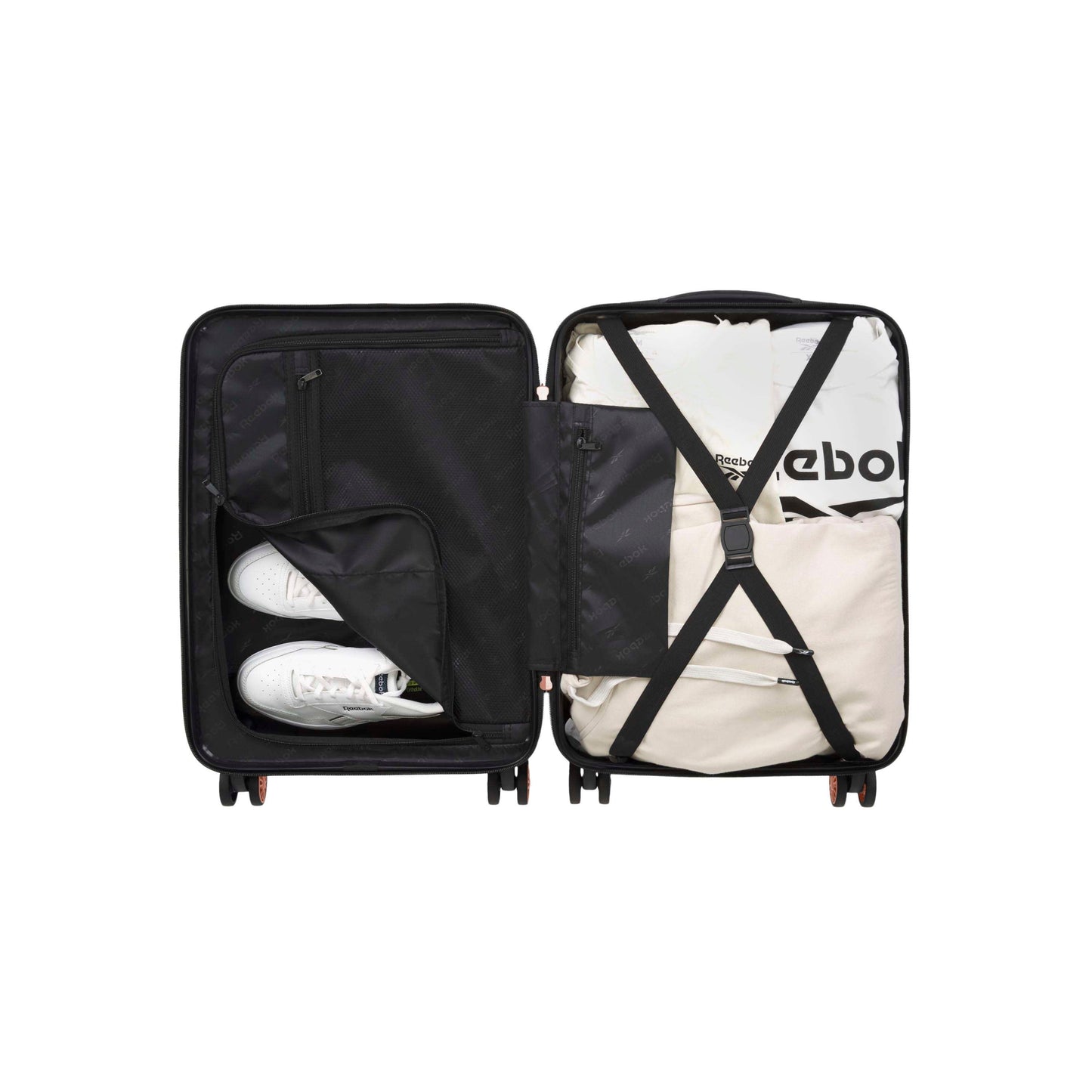 Open black suitcase with two compartments; left side holds a pair of white sneakers in a zippered mesh pocket, right side contains neatly packed clothing secured with crossed straps.