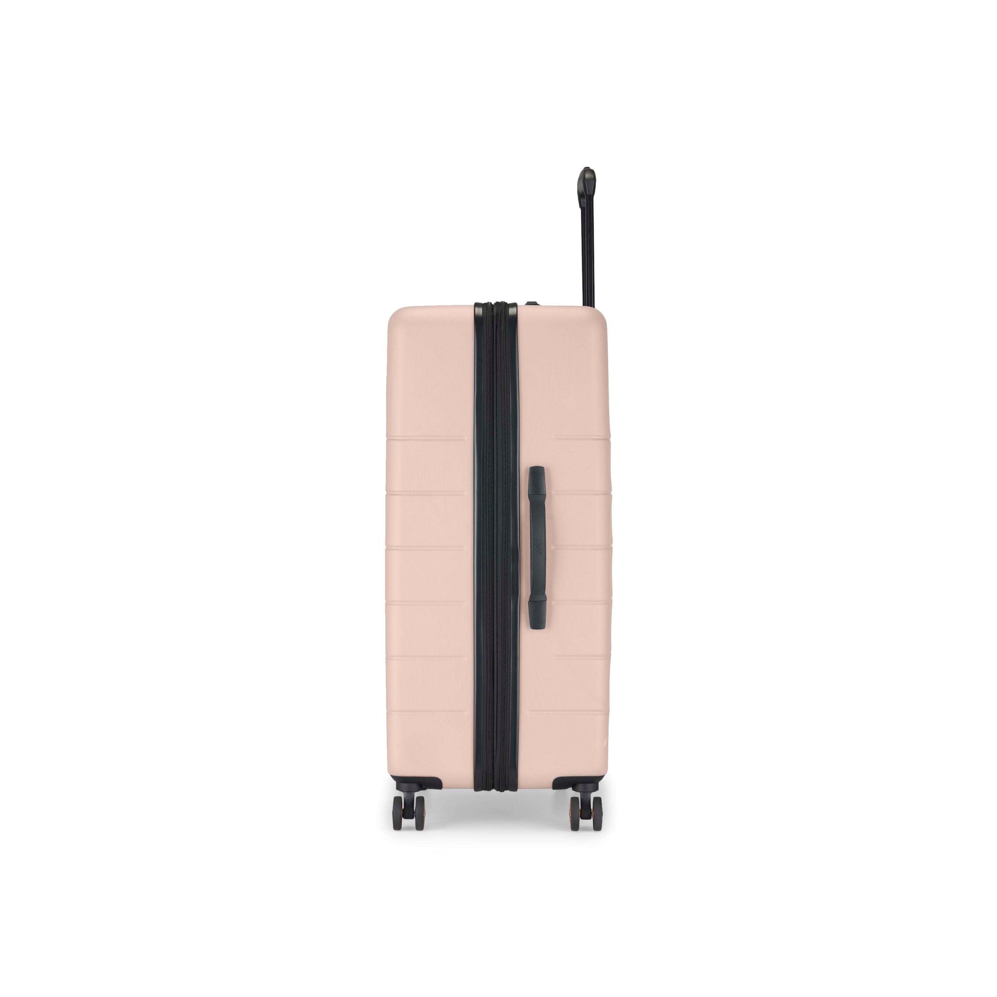 A beige hard-shell suitcase stands upright on four wheels, viewed from the side. It has a black zipper, black side handle, and an extended black telescoping handle against a white background.