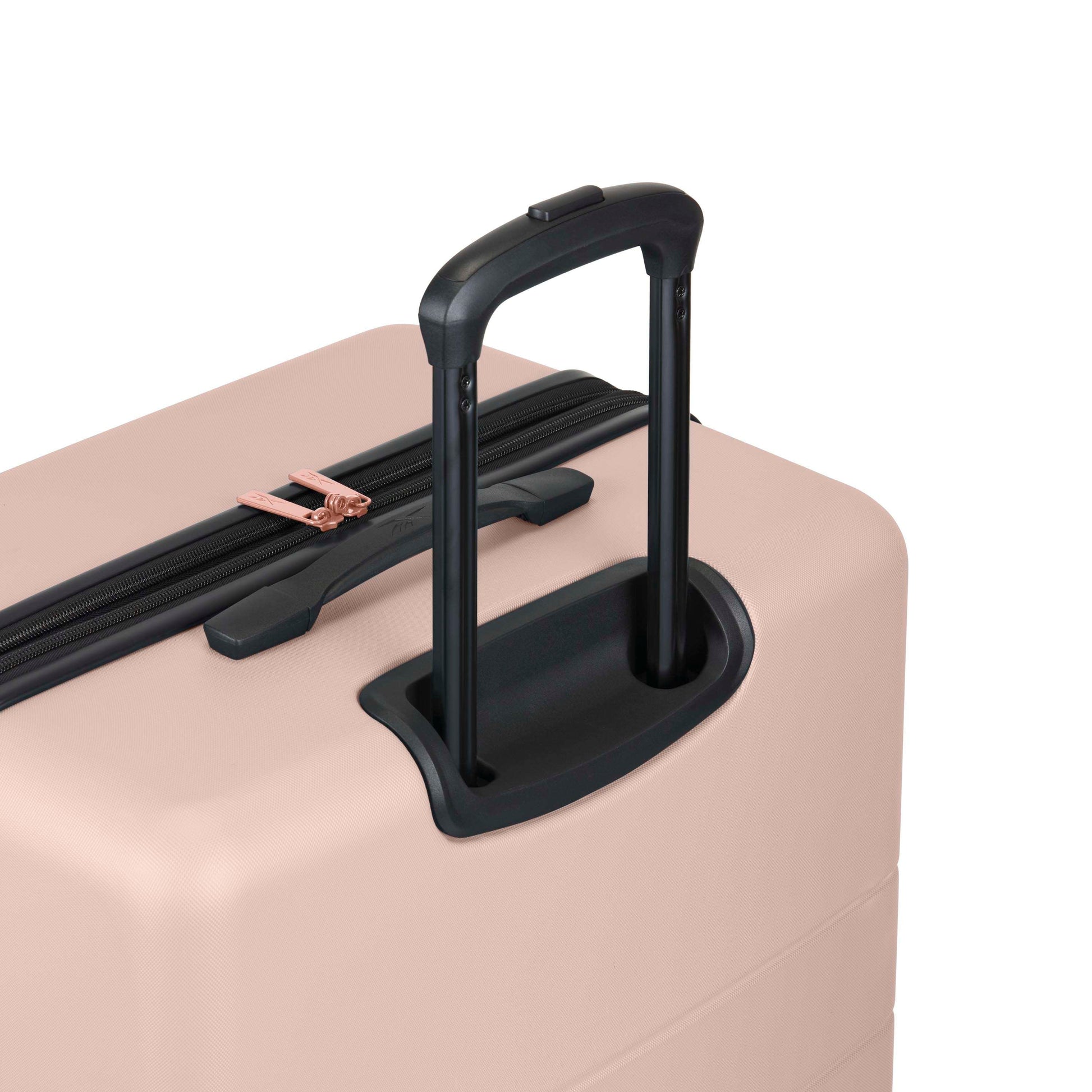 A close-up of a light pink hard-shell suitcase with a black telescopic handle extended and a zipper with rose gold accents.