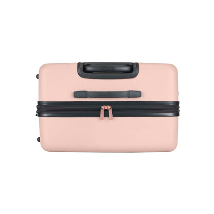 A closed, light pink hard-shell suitcase with black handles and black zipper, shown from the top against a white background.