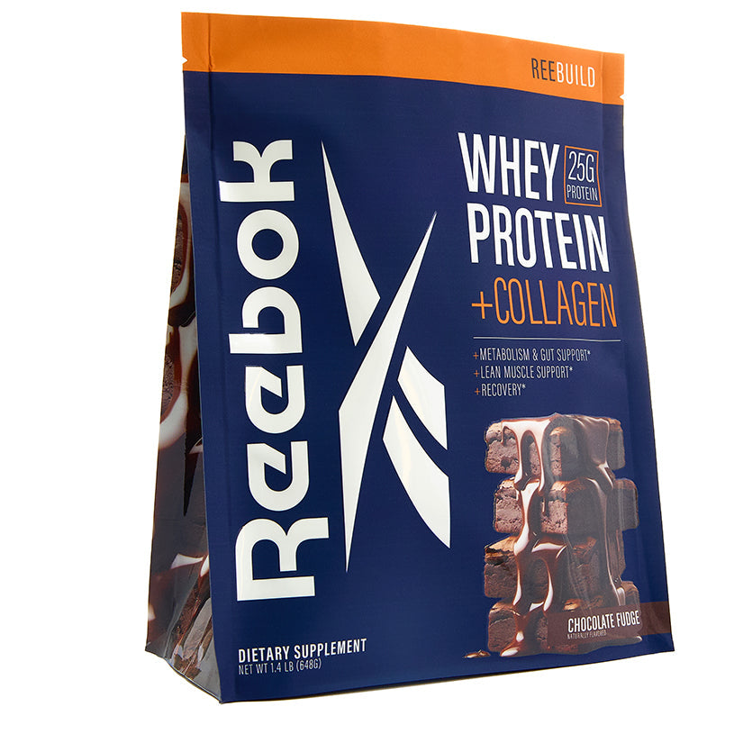 A blue and orange Reebok ReeBuild Whey Protein + Collagen bag in chocolate fudge flavor displays the logo, 25g protein per serving for muscle recovery, and chocolate square images on the front.