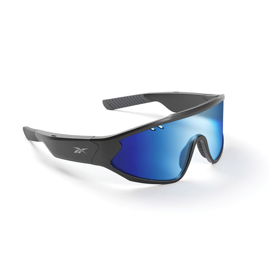 Reebok Voltage Smart Audio Sunglasses: black Bluetooth sport sunglasses with a thick frame, mirrored blue lenses, curved design, and the Reebok logo on the side. Shown on a plain white background.