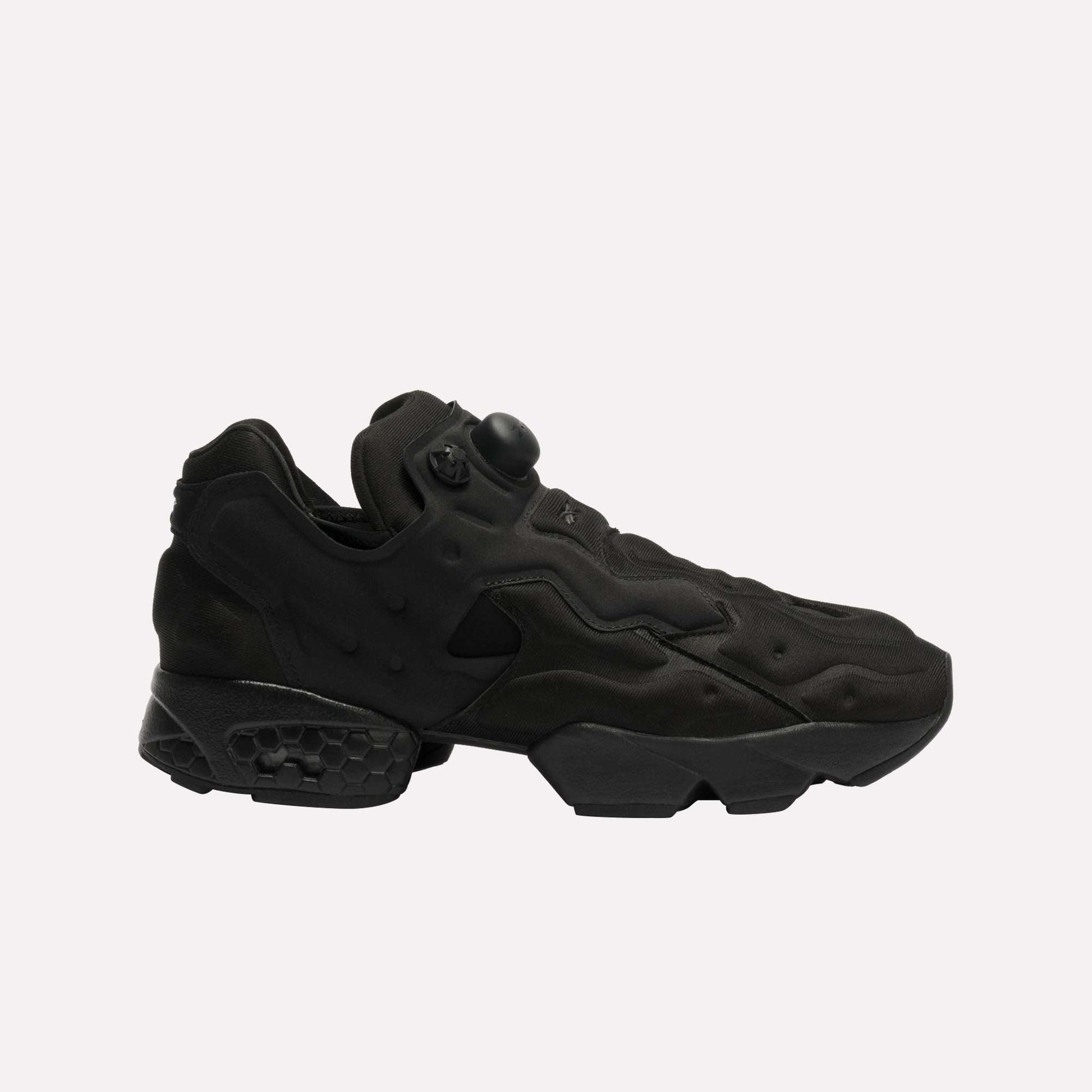 The Reebok Instapump Sliver LTD Shoes feature a futuristic black design with sculpted panels, a chunky sole with Hexalite cushioning, and an air pump system on the upper, displayed against a plain white background.