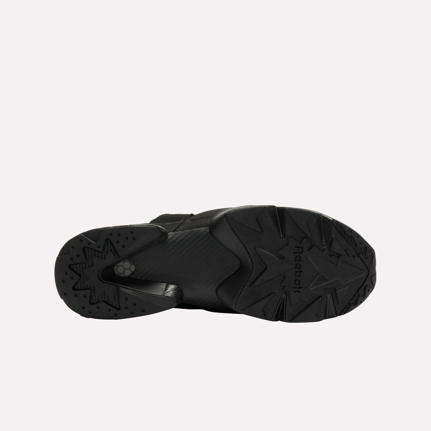 Bottom view of a single black Reebok Instapump Sliver LTD shoe with a chunky rubber sole, star-patterned tread, Hexalite cushioning, and the Reebok logo visible against a plain white background.