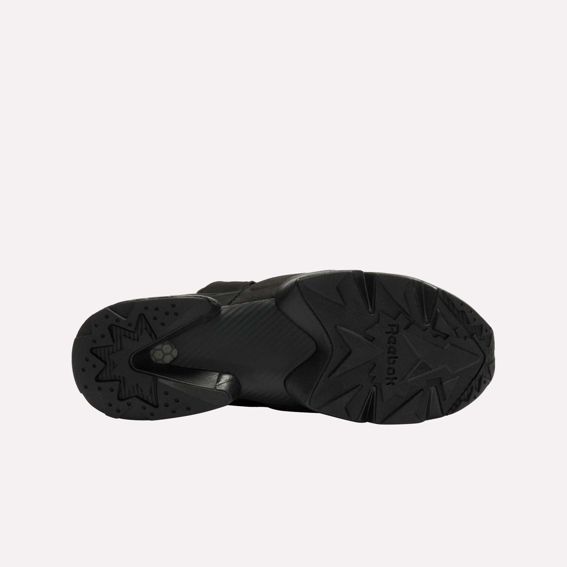 Bottom view of a single black Reebok Instapump Sliver LTD shoe with a chunky rubber sole, star-patterned tread, Hexalite cushioning, and the Reebok logo visible against a plain white background.