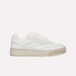 The Reebok Club C LTD Shoes are white low-top sneakers with a beige sole, perforated details, and white laces, shown in a side profile view—a timeless lifestyle classic inspired by tennis heritage.