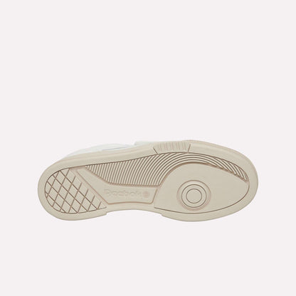 The image displays the beige rubber outsole of Reebok Club C LTD Shoes, featuring geometric tread patterns, the Reebok logo, and concentric circles near the toe for enhanced grip and traction.
