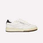 A white Reebok sneaker with a beige sole, black heel detail, and Reebok logo on the side, shown in a side profile on a plain white background.