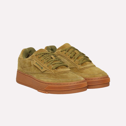 A pair of Reebok Club C LTD Shoes in tan suede with olive green laces and brown rubber soles, displayed side by side on a white background.