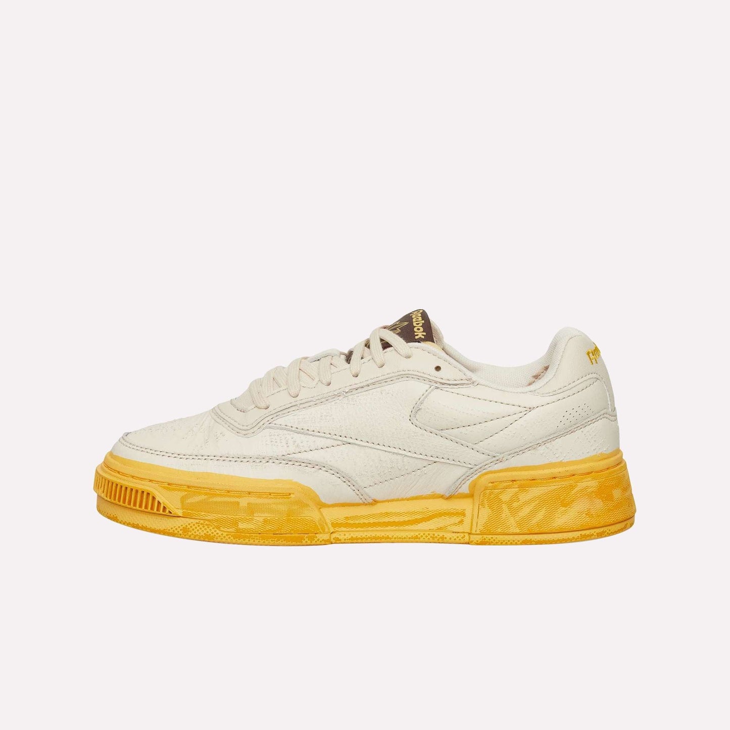 The Reebok Club C LTD Shoes feature a cream upper, textured yellow sole, low-top silhouette, and subtle side and tongue branding—an iconic lifestyle classic shown against a white background.