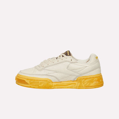 The Reebok Club C LTD Shoes feature a cream upper, textured yellow sole, low-top silhouette, and subtle side and tongue branding—an iconic lifestyle classic shown against a white background.