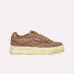 The Reebok Club C LTD Shoes feature a brown upper, chunky beige-cream sole, classic side branding, and brown laces. Shown in side profile, these tennis-inspired sneakers appear against a plain white background.