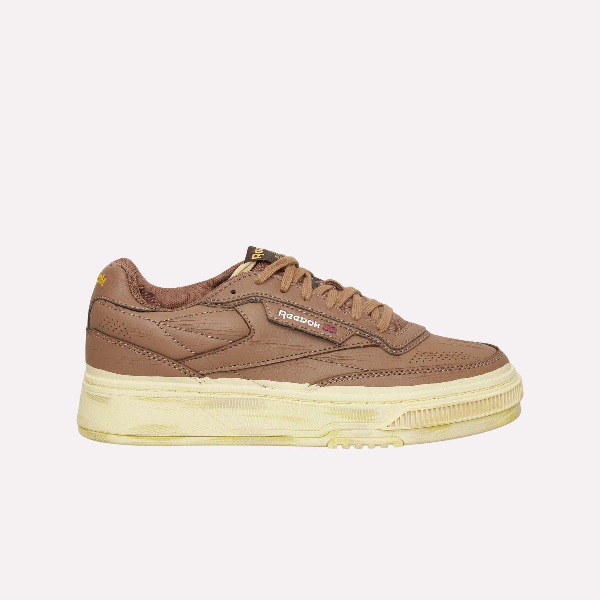 The Reebok Club C LTD Shoes feature a brown upper, chunky beige-cream sole, classic side branding, and brown laces. Shown in side profile, these tennis-inspired sneakers appear against a plain white background.