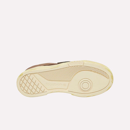 The image features the beige sole of a Reebok Club C LTD Shoe against a white background, showcasing its tread pattern and the embossed Reebok logo—a true lifestyle classic.