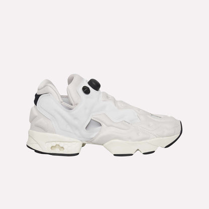 The Reebok Instapump Sliver Shoes are white and light gray sneakers with a chunky sole and unique cutout design, featuring Hexalite cushioning for comfort, displayed from the side on a light blue background.