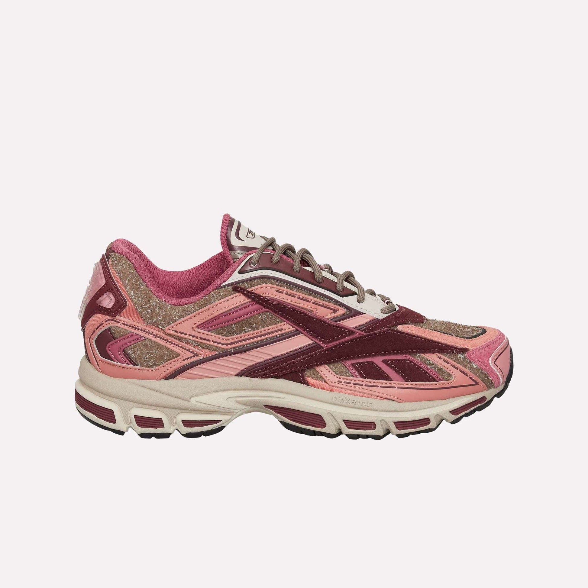 The Reebok Premier Road Ultra Shoes are stylish running sneakers in pink, burgundy, and light brown with mesh and suede uppers, a dual-density midsole, a white sole with dark accents, and a sporty, layered design.