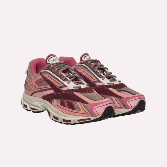 The Reebok Premier Road Ultra Shoes are stylish athletic sneakers in pink, burgundy, and beige with a chunky dual-density midsole, suede and mesh textures, intricate panels, and laces—perfect as modern running shoes.