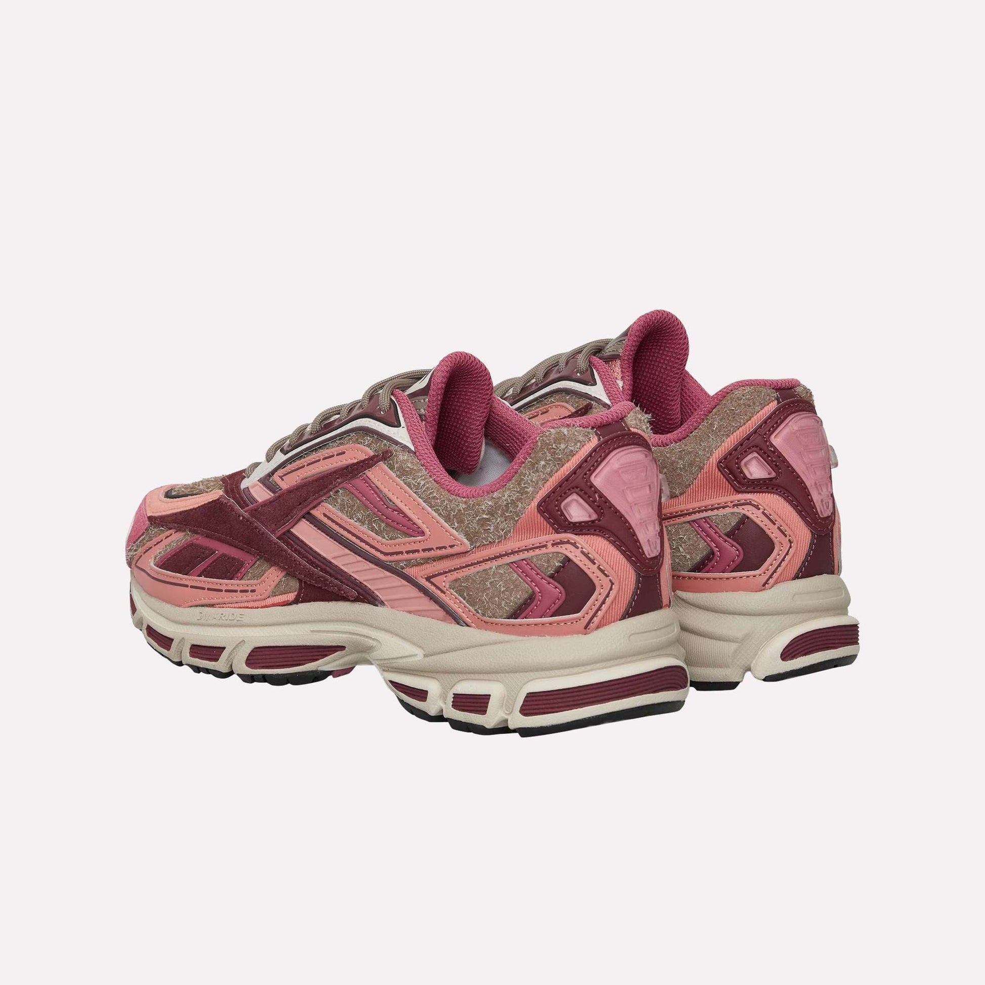 A pair of Reebok Premier Road Ultra Shoes in pink and maroon with textured suede and mesh, white soles, dual-density midsole, and maroon accents, viewed from a rear side angle on a white background.
