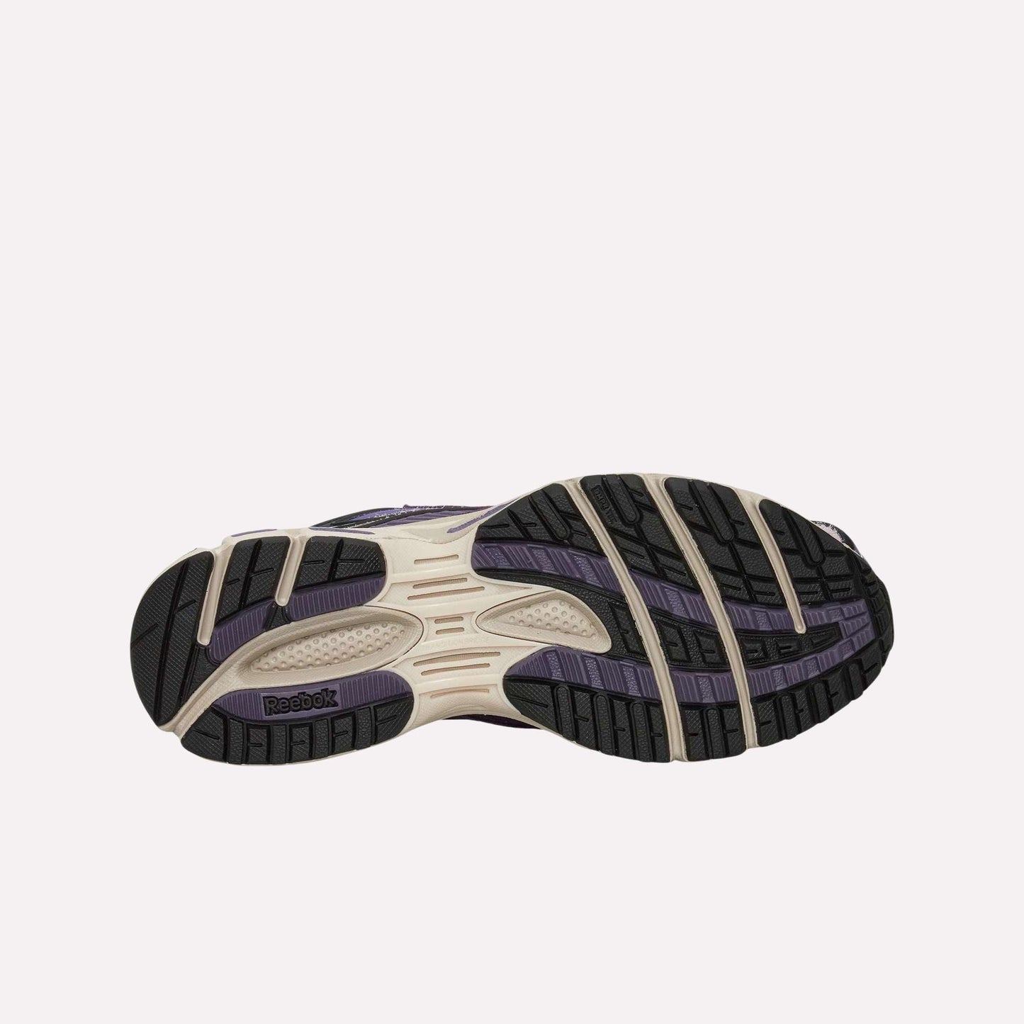 The image displays the sole of the Reebok Premier Road Ultra Shoes, with a patterned black and purple tread, cream accents, textured grip zones, and a visible Reebok logo near the heel.