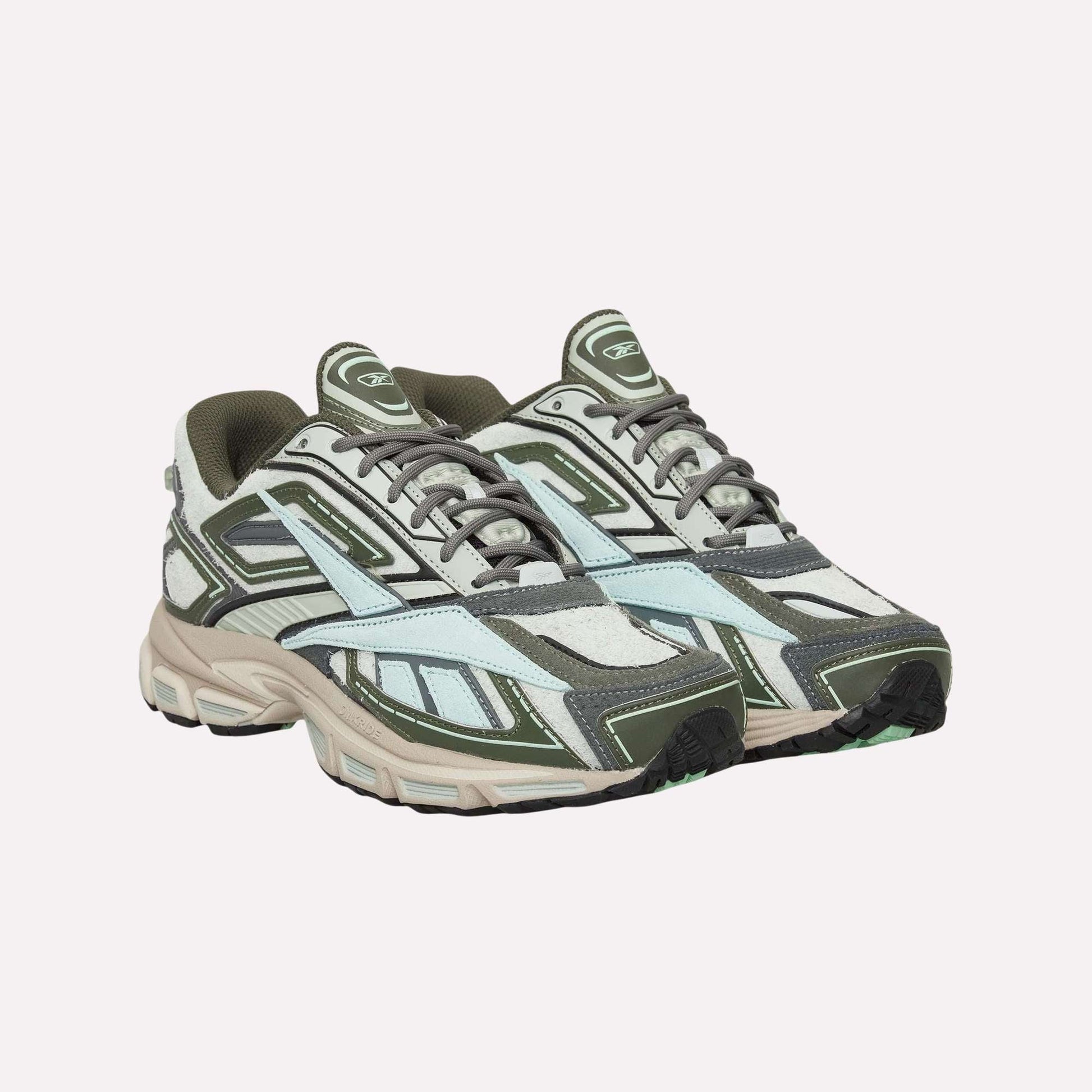 Reebok Premier Road Ultra Shoes with olive green, grey, white, and light blue panels and thick dual-density midsoles are shown against a plain light blue background.