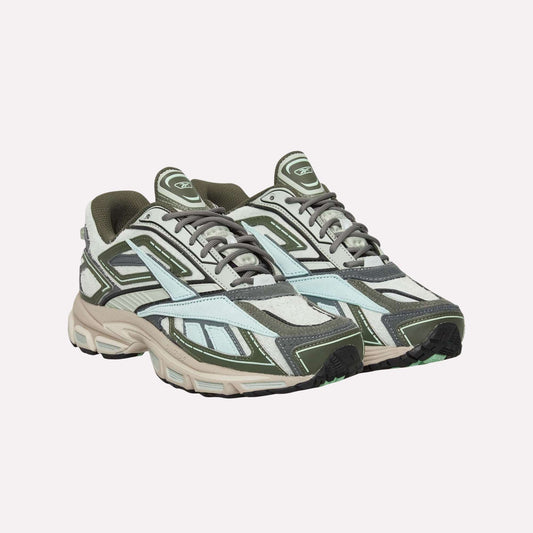 Reebok Premier Road Ultra Shoes with olive green, grey, white, and light blue panels and thick dual-density midsoles are shown against a plain light blue background.