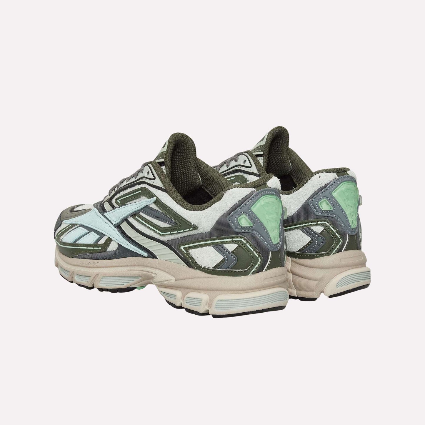 A pair of Reebok Premier Road Ultra Shoes in green, white, and mint with chunky beige soles and a dual-density midsole is displayed on a light blue background, shown from the back and side.