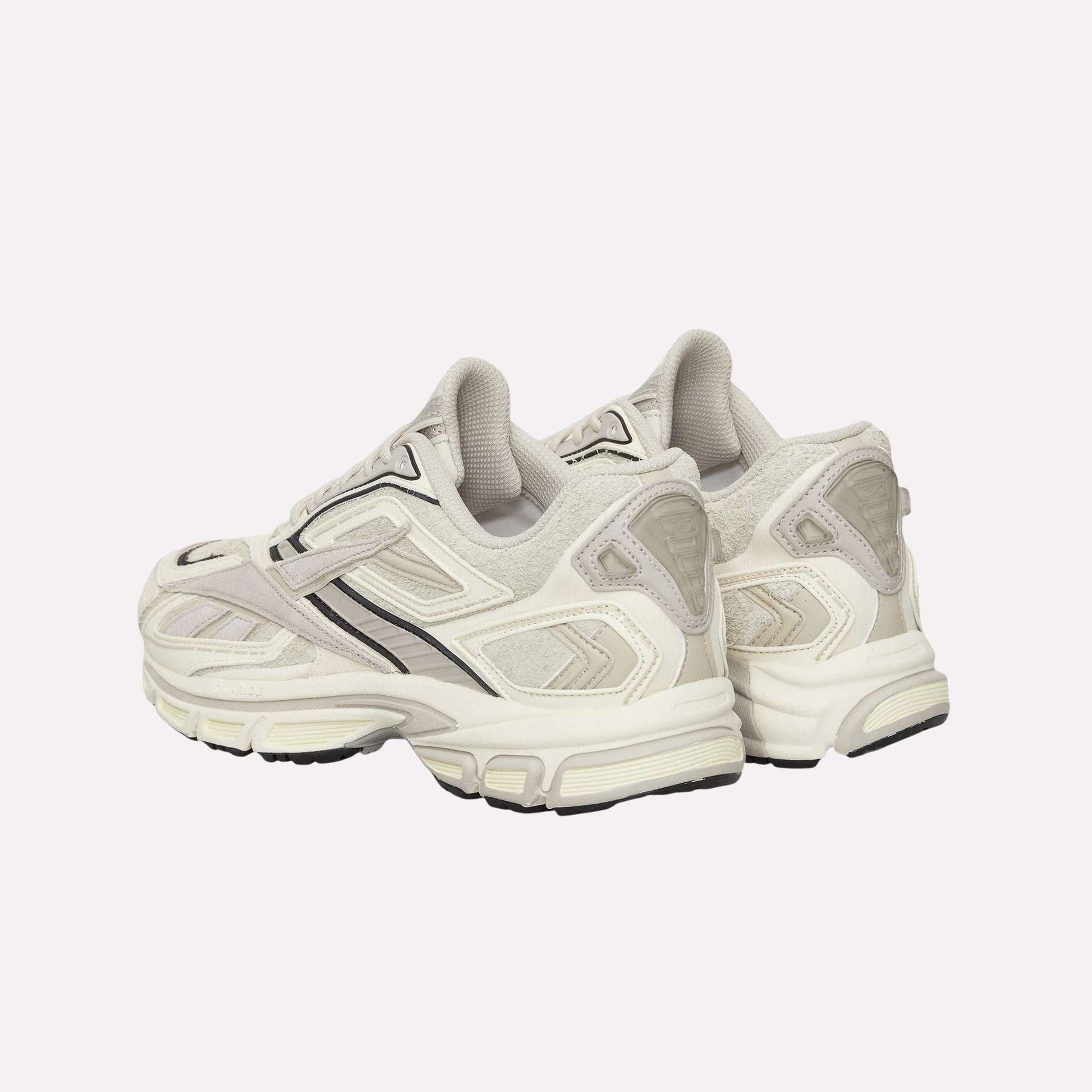 A pair of off-white and light gray Reebok Premier Road Ultra Shoes with black accents and a dual-density midsole are displayed on a plain light blue background, showing both the sides and backs.