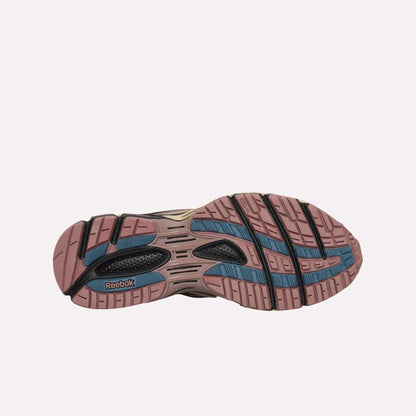 The image displays the sole of Reebok Premier Road Ultra Shoes, showing a mauve pink textured tread with blue and black accents against a light blue background.