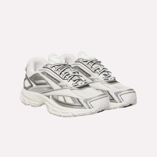 A pair of Reebok Premier Road Ultra Shoes in white with gray and silver accents, mesh panels, detailed stitching, and thick textured soles with a dual-density midsole, positioned side by side facing slightly right.