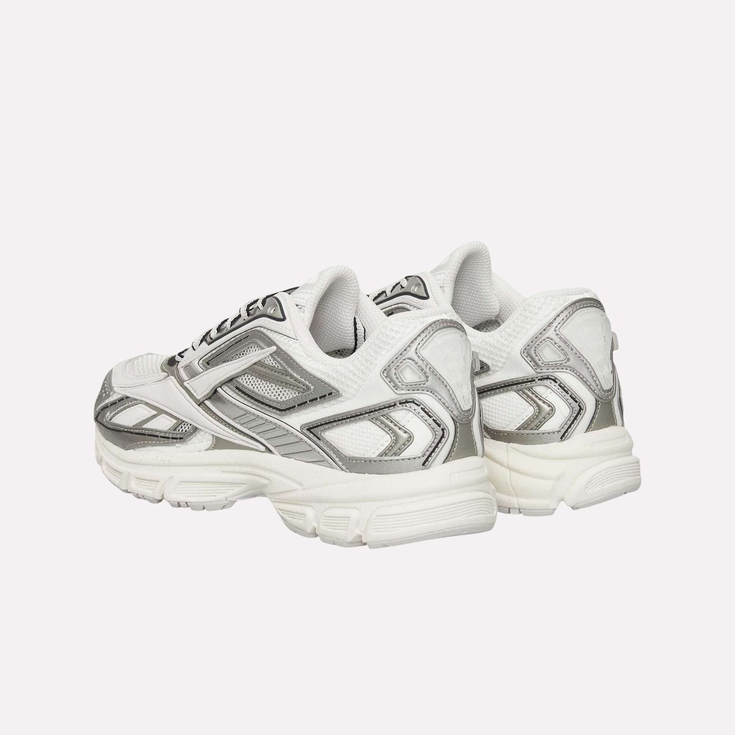 A pair of Reebok Premier Road Ultra Shoes in white and silver are placed back-to-back, highlighting chunky soles, layered mesh and synthetic panels, plus a dual-density midsole designed for comfort.