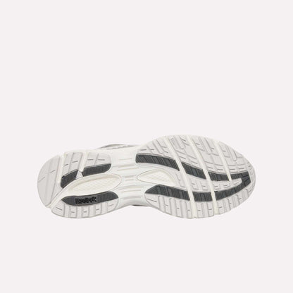 The bottom view shows the white Reebok Premier Road Ultra Shoes sole with black and gray traction, designed for grip and stability, complementing this archival running sneaker’s dual-density midsole.