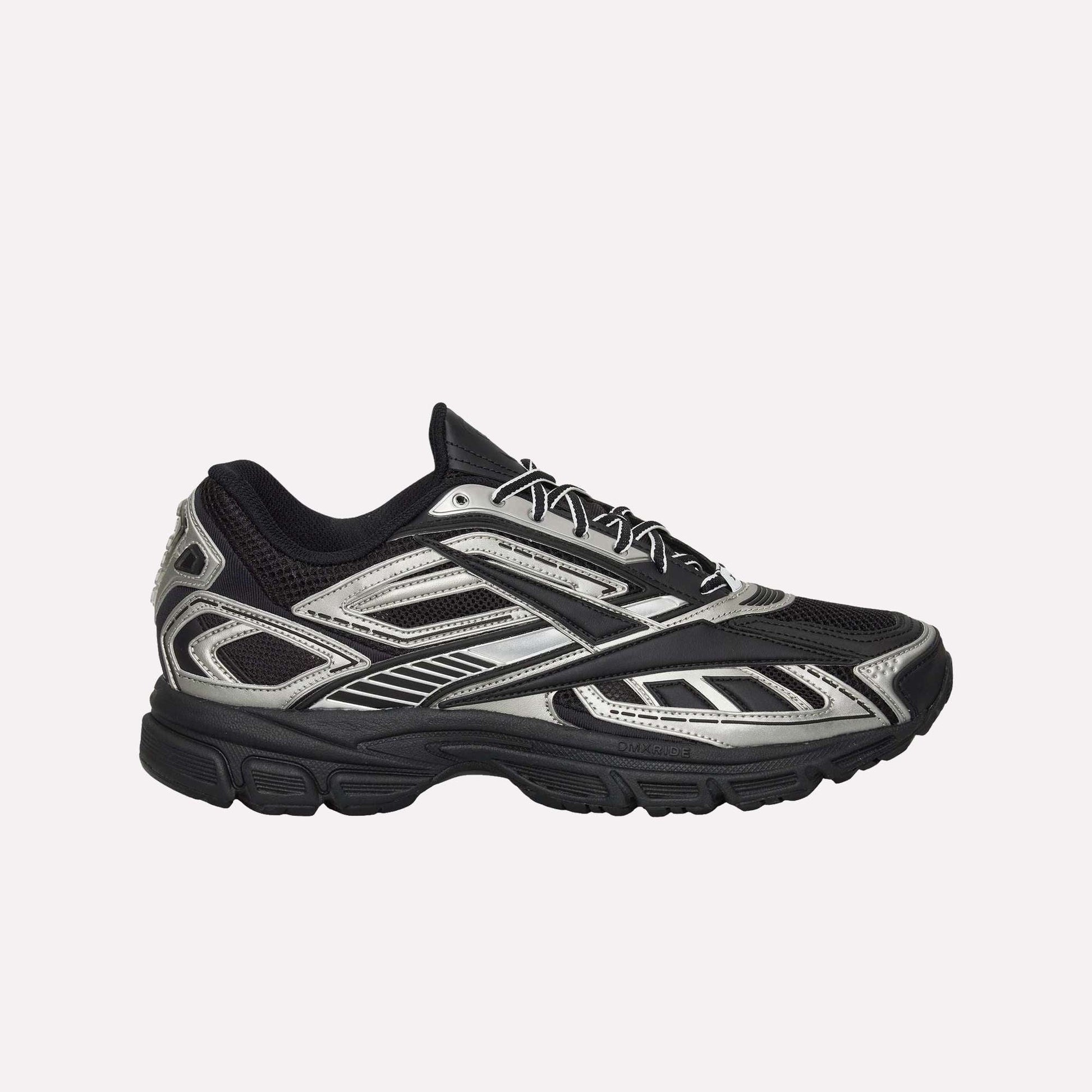 The Reebok Premier Road Ultra Shoes feature a black mesh upper with metallic silver accents, black laces, angular patterns, a chunky dual-density rubber sole, and boast a modern, sporty look.